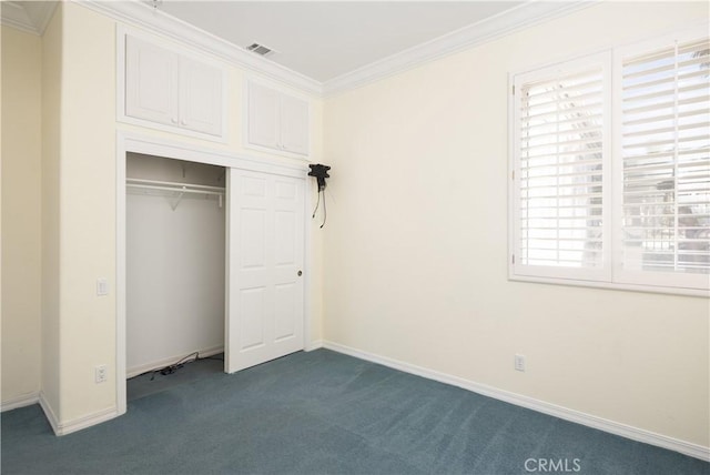 unfurnished bedroom with crown molding, a closet, and dark carpet