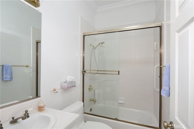 full bathroom with vanity, toilet, enclosed tub / shower combo, and crown molding