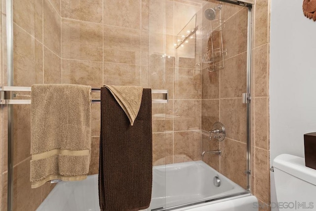 bathroom featuring toilet and enclosed tub / shower combo