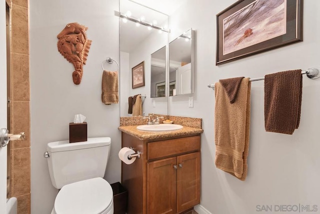 bathroom featuring toilet and vanity