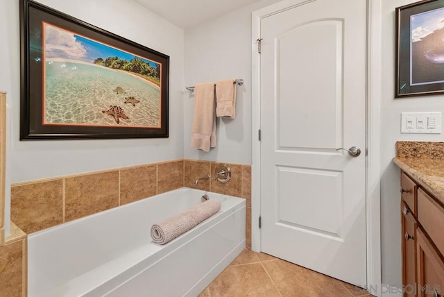 bathroom featuring tile patterned flooring, vanity, and a bathing tub