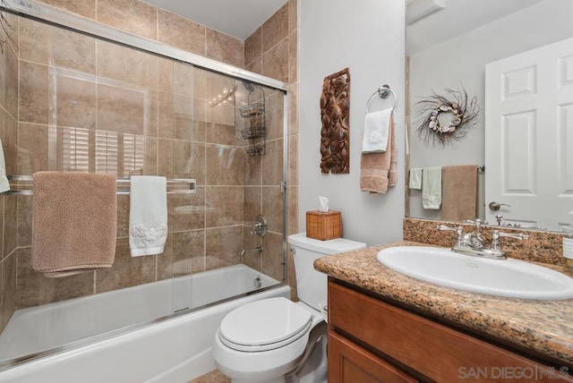 full bathroom with toilet, combined bath / shower with glass door, and vanity