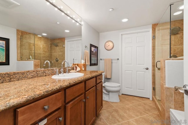 bathroom featuring tile patterned floors, an enclosed shower, vanity, and toilet