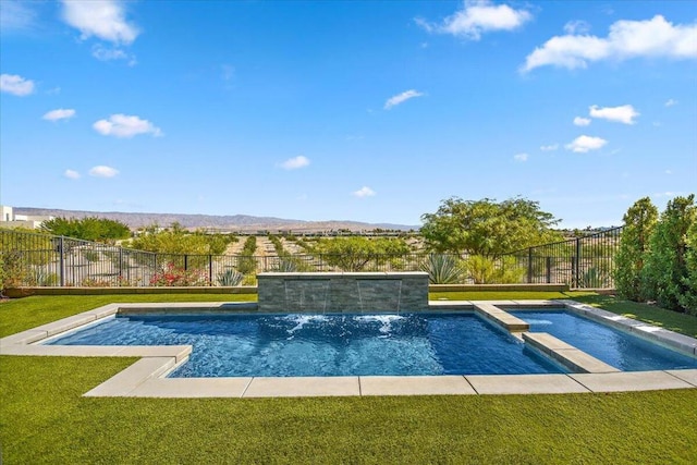 view of pool with a mountain view, a yard, pool water feature, and an in ground hot tub