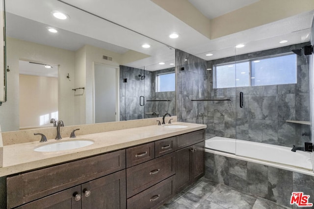 bathroom with vanity, combined bath / shower with glass door, and a wealth of natural light