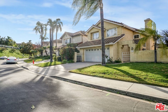 view of front of house featuring a front yard and a garage