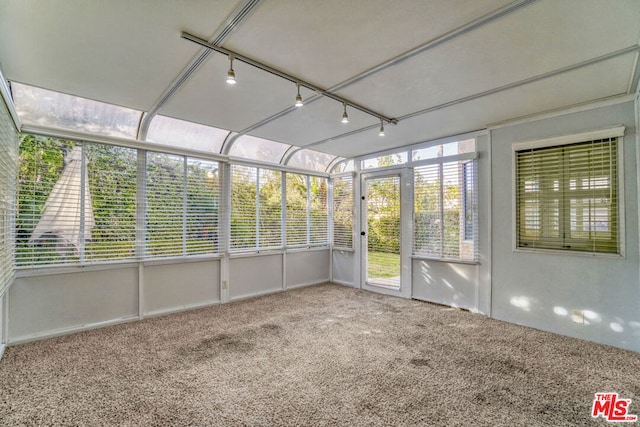 unfurnished sunroom featuring track lighting