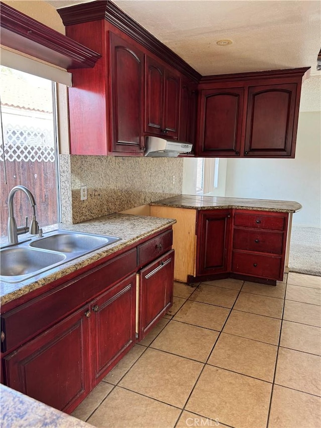 kitchen with sink, light tile patterned floors, and decorative backsplash