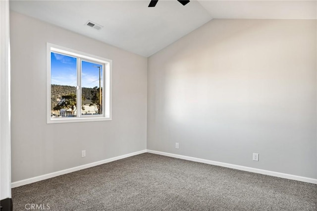 carpeted spare room featuring lofted ceiling and ceiling fan