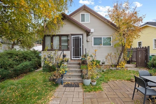 view of front of house featuring a front yard and a patio