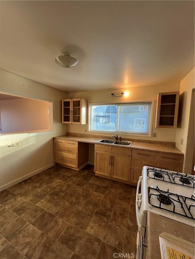 kitchen with sink, light brown cabinets, and white range with gas stovetop