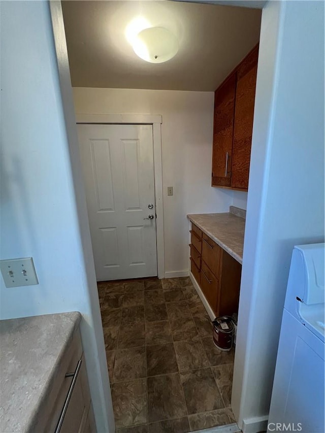 laundry room with washer and clothes dryer and cabinets