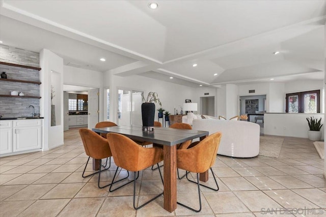 dining space with plenty of natural light, light tile patterned flooring, and sink