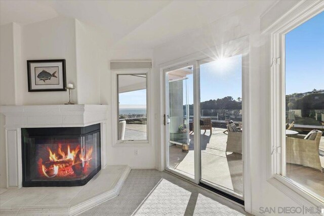 carpeted living room featuring vaulted ceiling