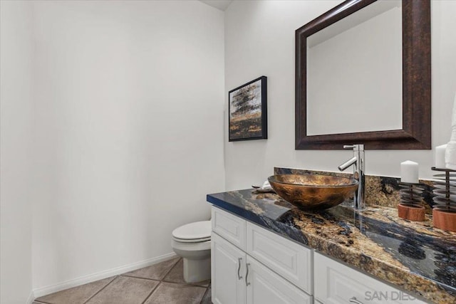 bathroom featuring tile patterned flooring, vanity, and toilet