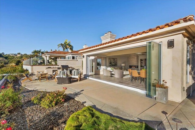 rear view of property featuring a patio