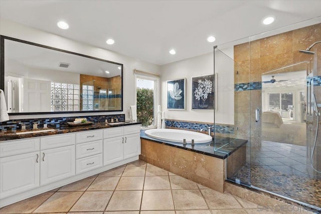 bathroom with tile patterned floors, vanity, ceiling fan, and plus walk in shower