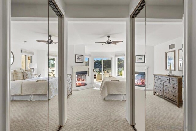 bedroom with ceiling fan and light carpet