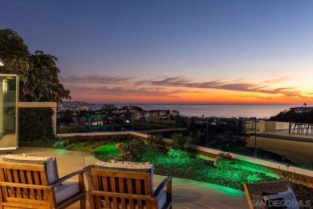 pool at dusk with a water view