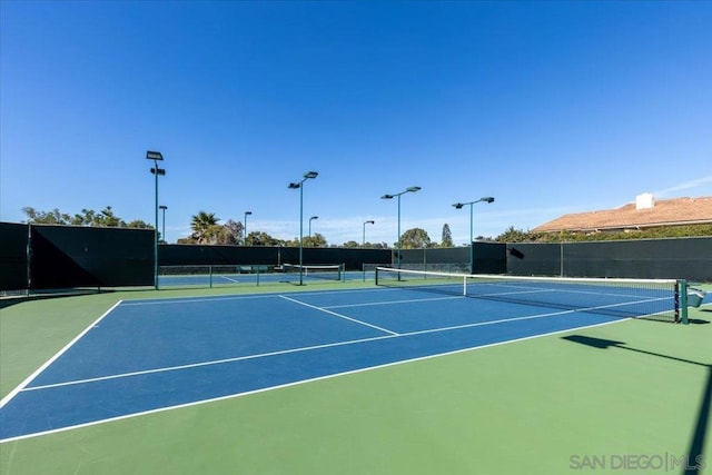 view of tennis court featuring basketball court