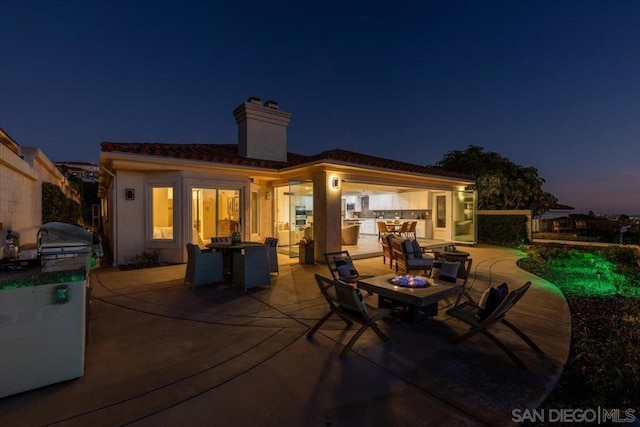 exterior space featuring a fire pit and a grill