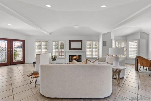 living room featuring french doors, light tile patterned floors, and a healthy amount of sunlight