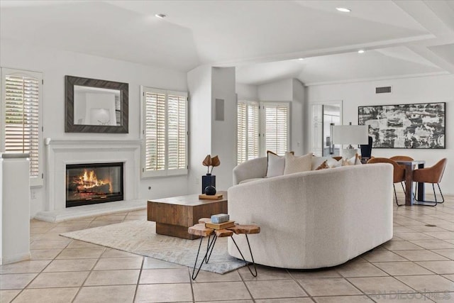 living room featuring light tile patterned floors, a wealth of natural light, and vaulted ceiling