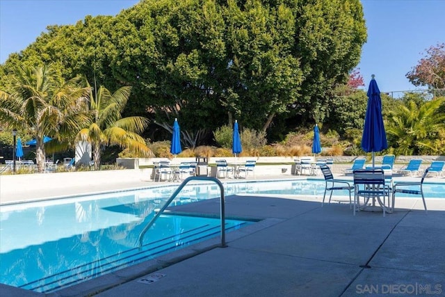 view of swimming pool featuring a patio area