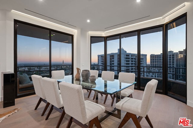 dining space with light hardwood / wood-style flooring