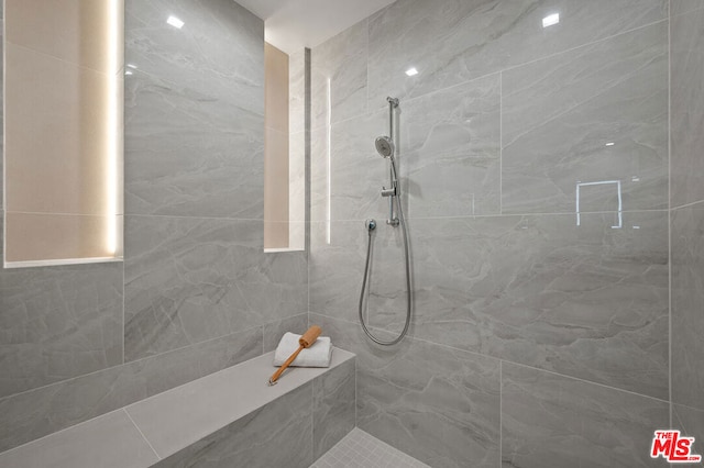 bathroom with tiled shower