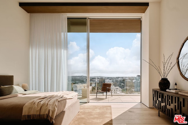 bedroom featuring access to outside and light hardwood / wood-style flooring