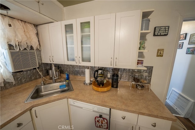 kitchen featuring backsplash, dishwasher, white cabinetry, and sink