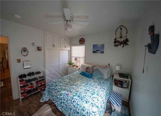 bedroom with ceiling fan and dark hardwood / wood-style floors