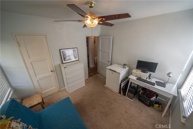 carpeted office space featuring ceiling fan