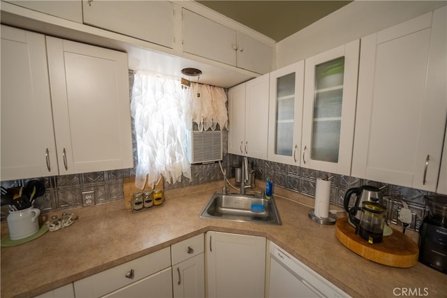 kitchen with white cabinets, decorative backsplash, dishwasher, and sink