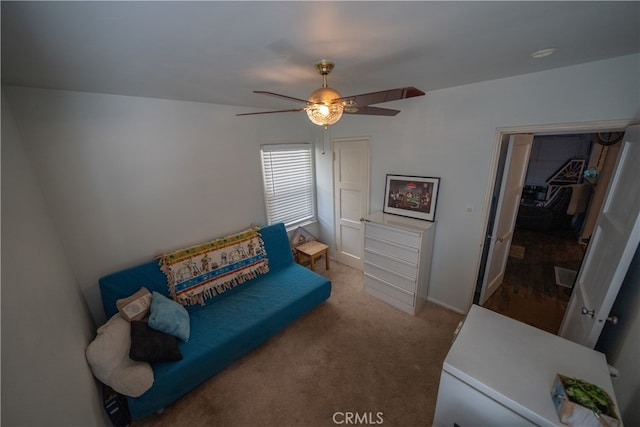 sitting room with ceiling fan and carpet floors