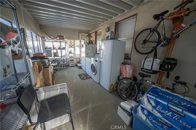 interior space with washing machine and dryer and white refrigerator