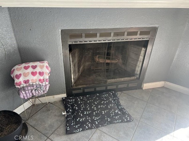 interior details featuring a tiled fireplace