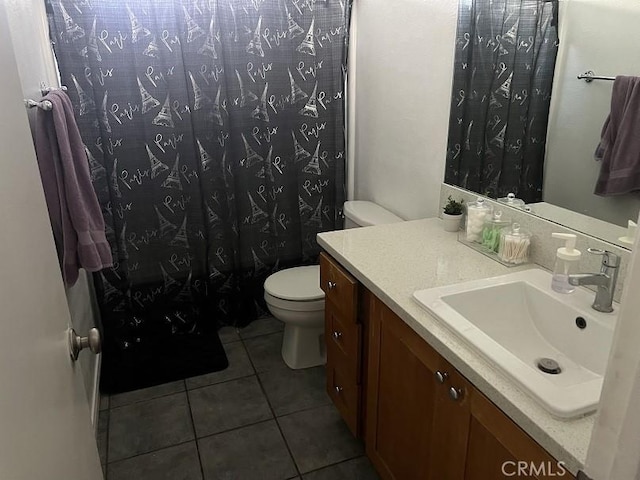 bathroom featuring tile patterned flooring, vanity, toilet, and a shower with shower curtain