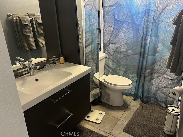 bathroom with tile patterned floors, vanity, and toilet