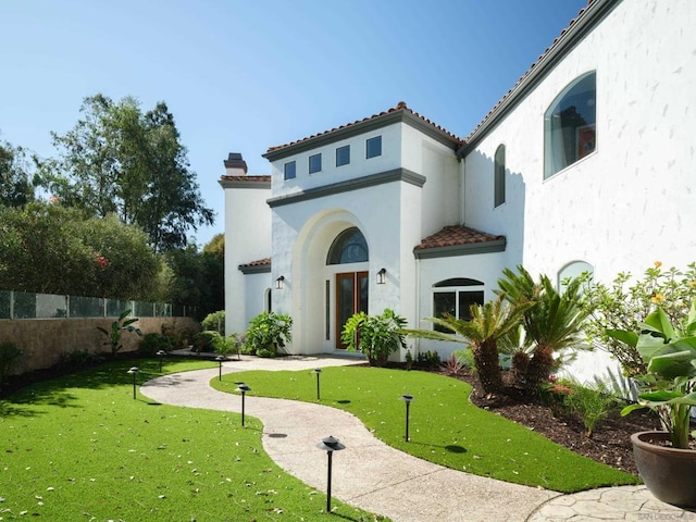 rear view of house with a yard