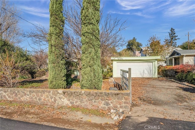 view of front of house featuring an outdoor structure and a garage