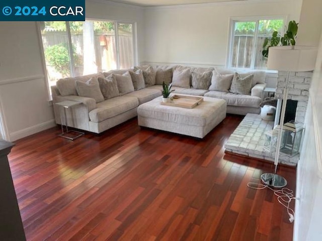 living room with dark hardwood / wood-style flooring and ornamental molding