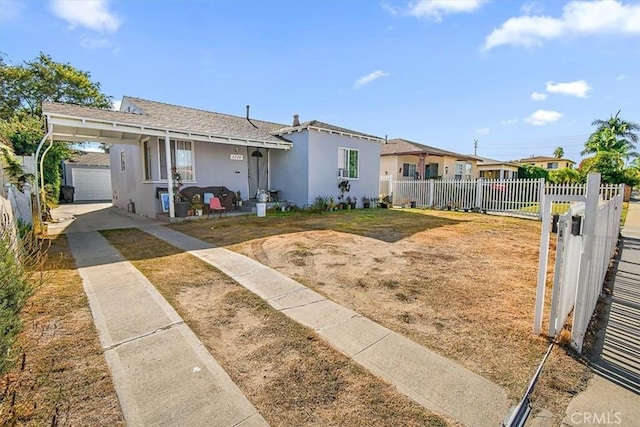 view of front of property featuring a garage and an outdoor structure