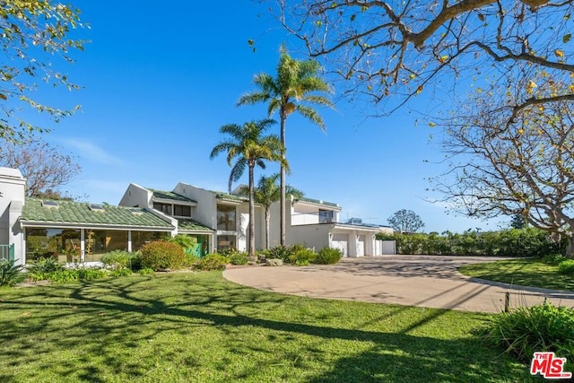 view of front of property with a front yard and a garage