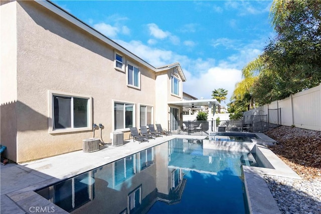 view of swimming pool featuring central AC, ceiling fan, and a patio