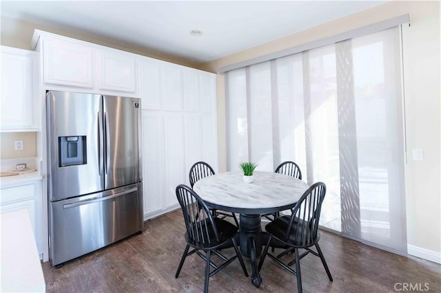 dining area with dark hardwood / wood-style flooring