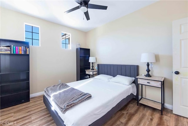 bedroom with ceiling fan and wood-type flooring