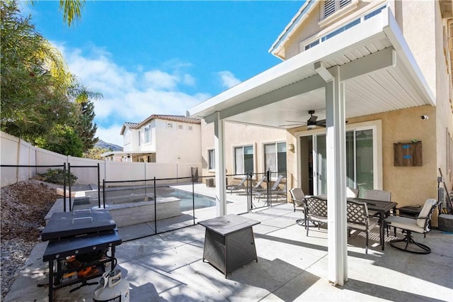 view of patio featuring a fenced in pool, ceiling fan, and a grill