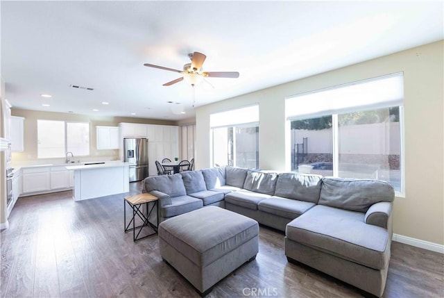 living room with dark hardwood / wood-style floors and ceiling fan